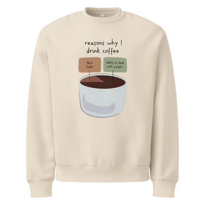 Beige sweatshirt with a graphic of a coffee cup and text 'reasons why I drink coffee' on a white background