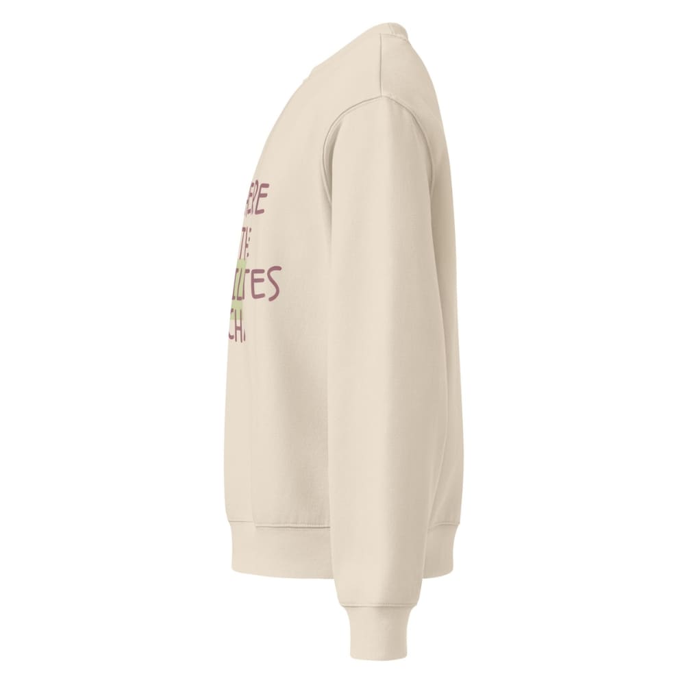 Beige hoodie with text on the sleeve against a white background