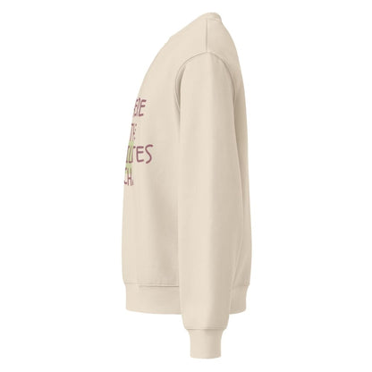 Beige hoodie with text on the sleeve against a white background
