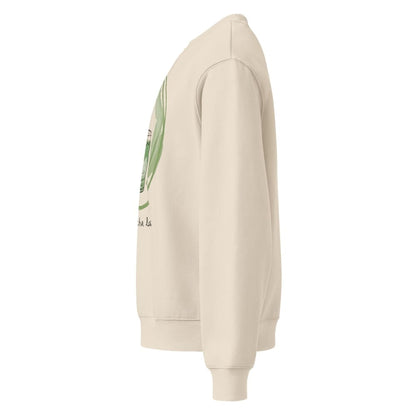 Beige hoodie with a graphic design on the sleeve against a white background