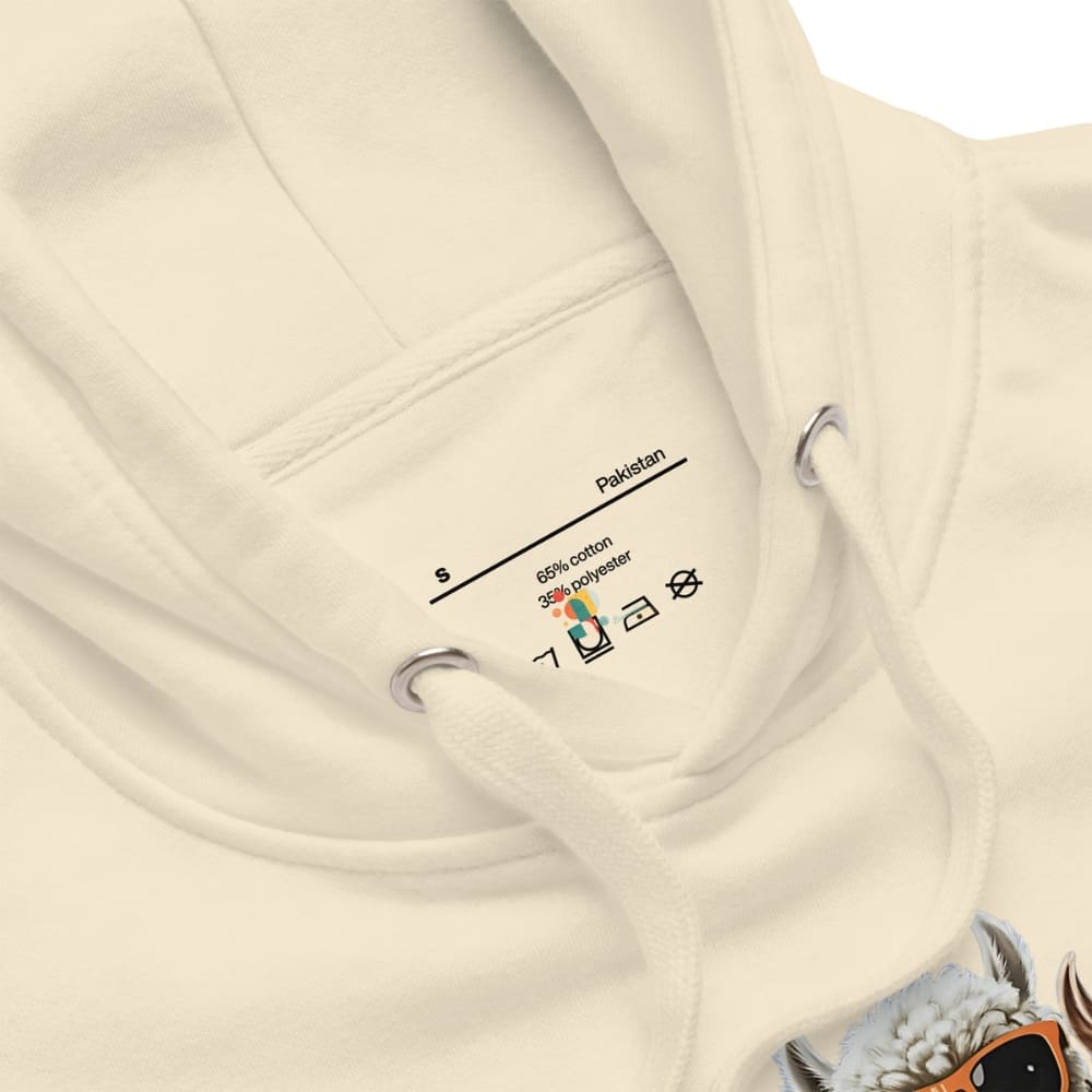 Close-up of a beige hoodie with a label on a white background