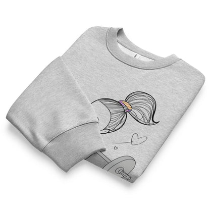 Folded gray sweatshirt with a colorful bow design on a white background