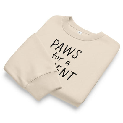 Beige sweatshirt with 'PAWS for a PLENT' text on a white background