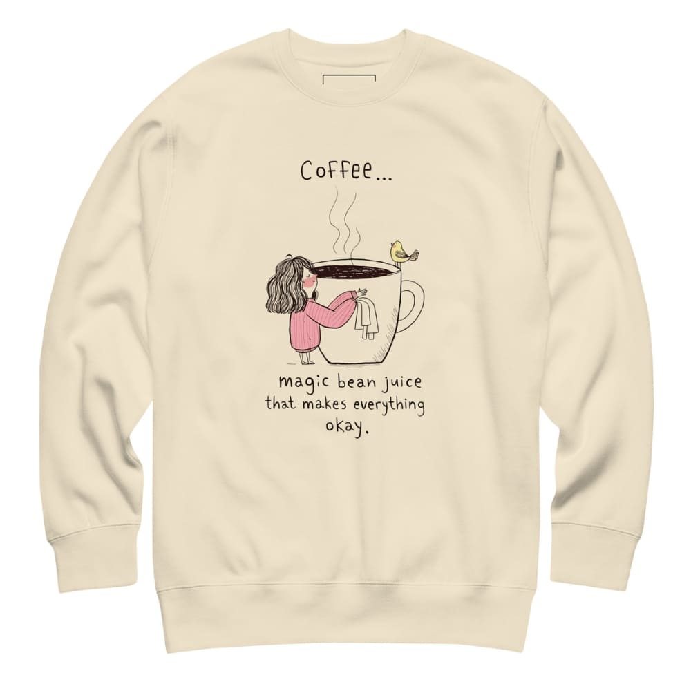 Beige sweatshirt with a graphic of a person holding a coffee cup and text on a white background