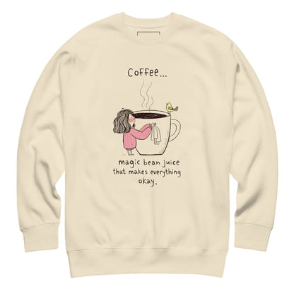 Beige sweatshirt with a graphic of a person holding a coffee cup and text on a white background