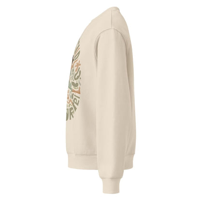 Beige hoodie with a colorful graphic on the sleeve against a white background