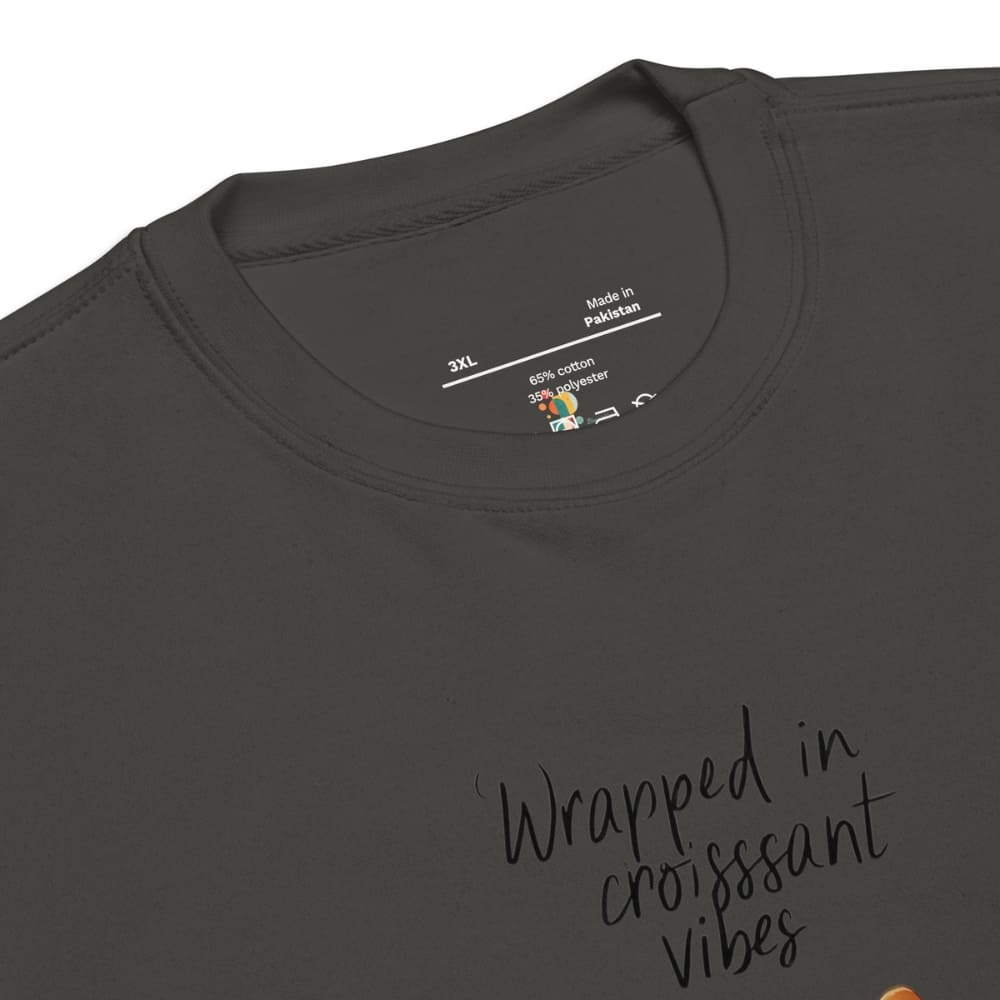 Dark gray t-shirt with 'Wrapped in croissant vibes' text and brand label on a white background