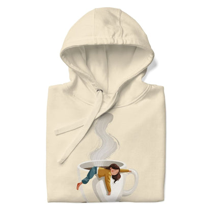 Beige hoodie with a graphic of a person in a coffee cup on a white background