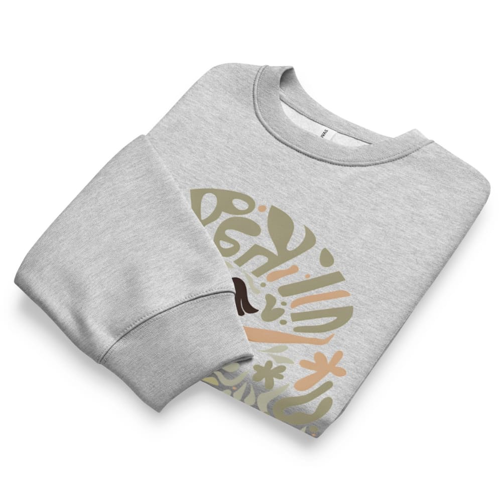 Folded gray sweatshirt with colorful graphic design on a white background
