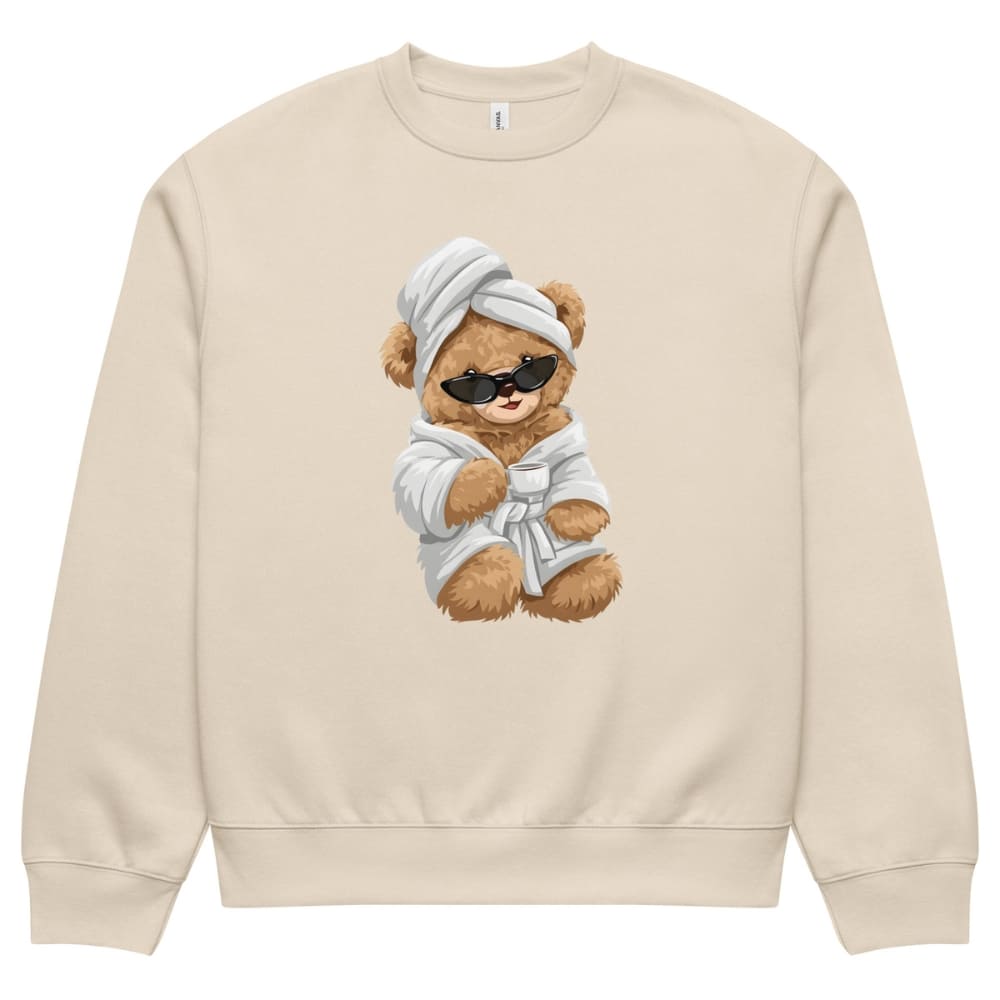 Beige sweatshirt with a teddy bear design wearing sunglasses, a robe, and a towel on a white background