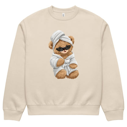 Beige sweatshirt with a teddy bear design wearing sunglasses, a robe, and a towel on a white background