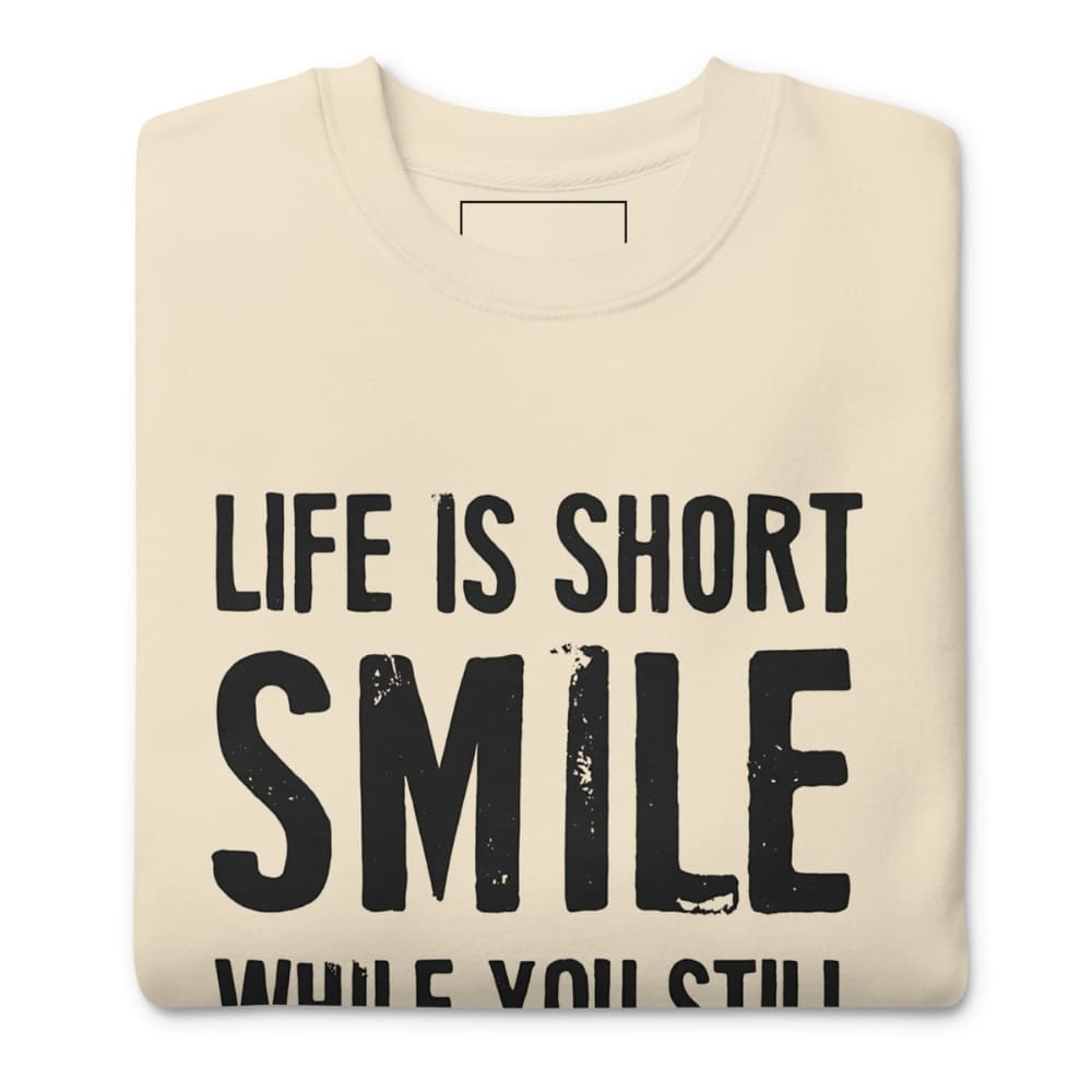 Beige sweatshirt with 'Life is short, smile while you still can' text on a white background