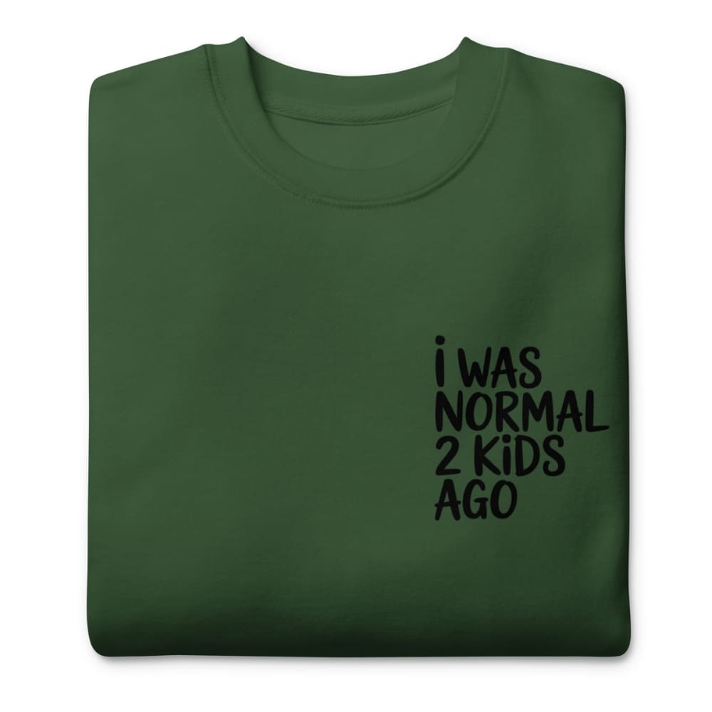 Green t-shirt with black text 'I WAS NORMAL 2 KIDS AGO' on a white background