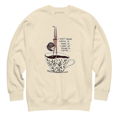 Beige sweatshirt with a coffee-themed graphic and text on a white background