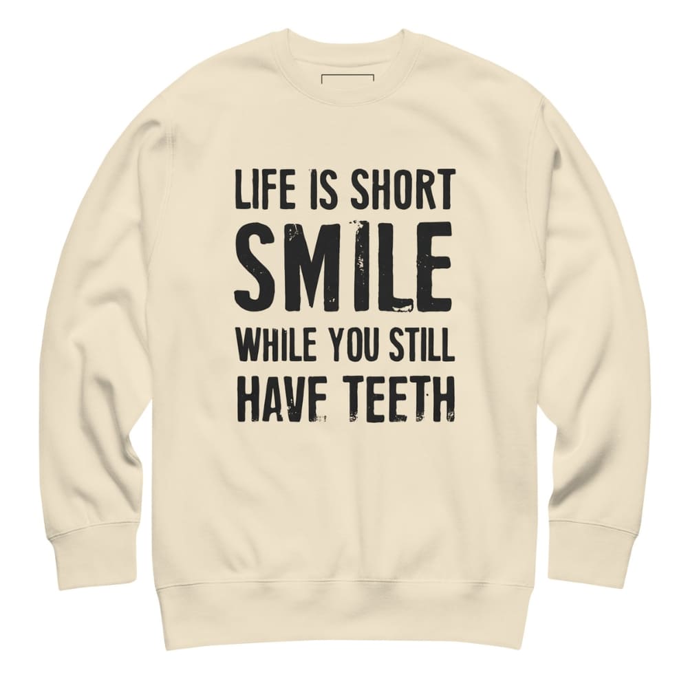 Beige sweatshirt with black text 'Life is short, smile while you still have teeth' on a white background