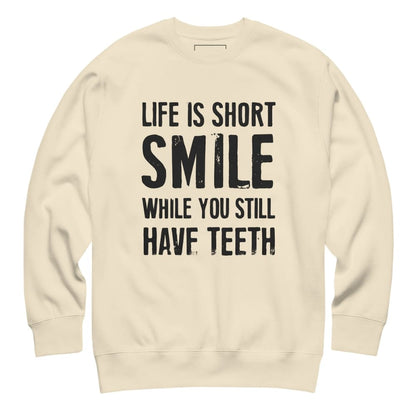Beige sweatshirt with black text 'Life is short, smile while you still have teeth' on a white background