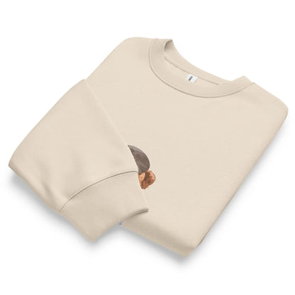 Beige sweatshirt with a small graphic on a white background
