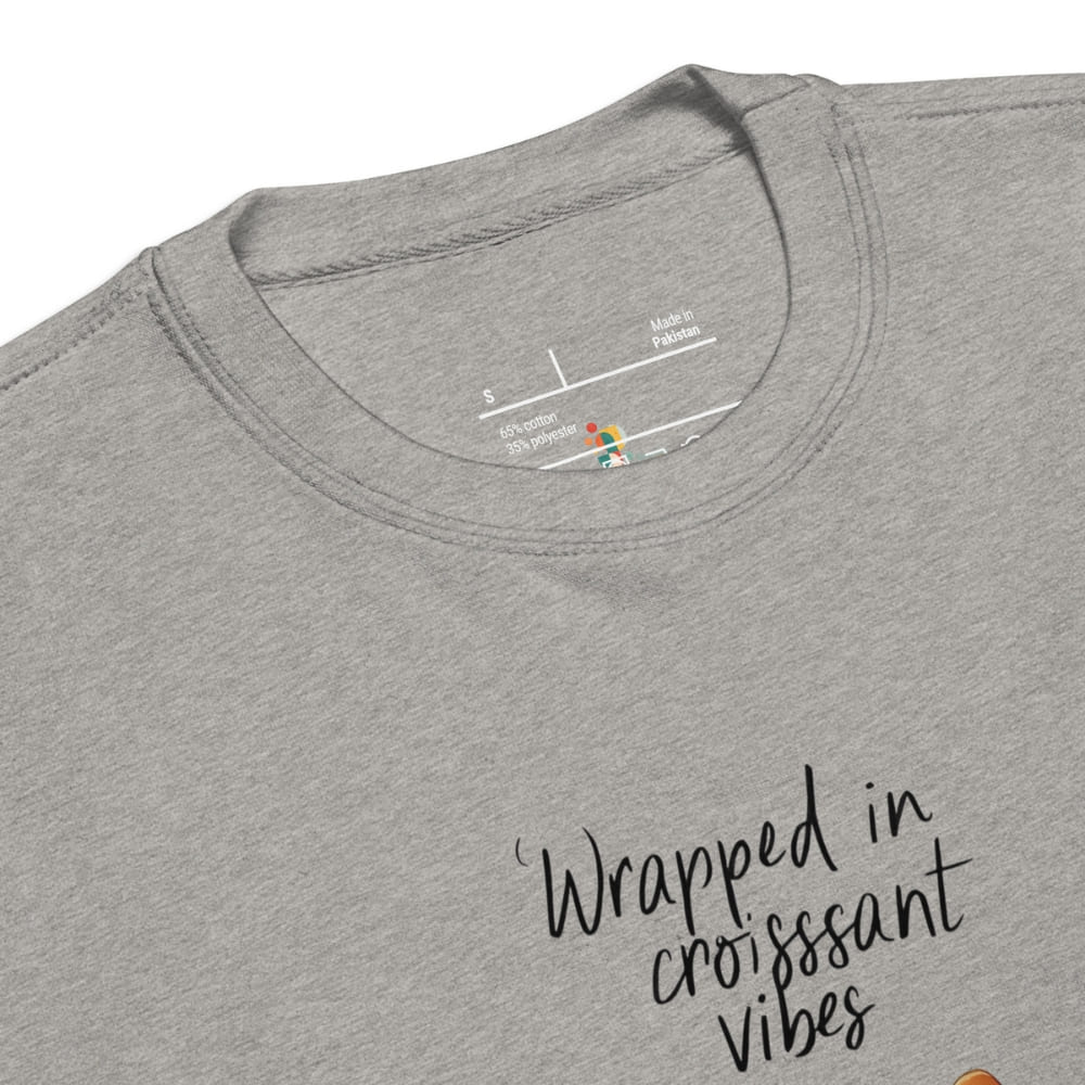Gray t-shirt with 'Wrapped in croissant vibes' text and brand label.