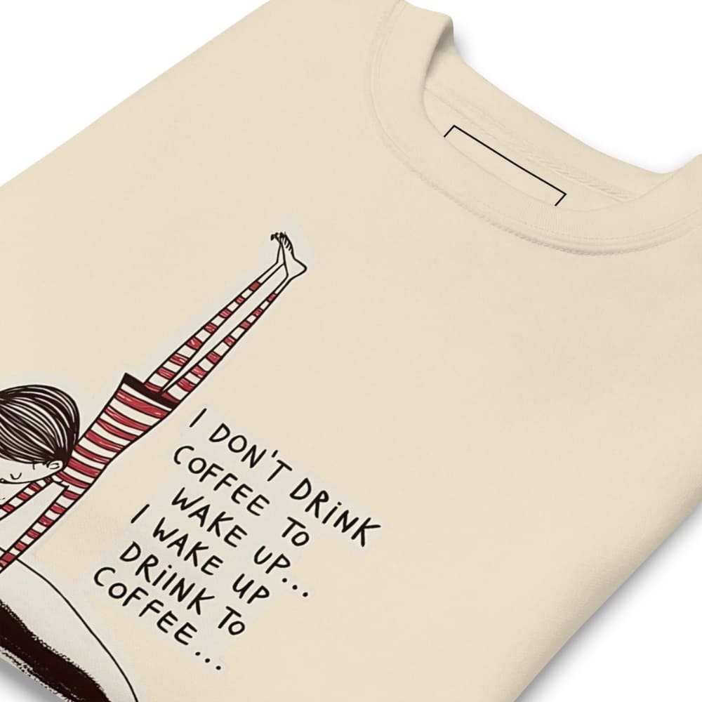 Beige t-shirt with a graphic of a person drinking coffee and text on a white background