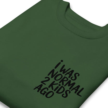 Green t-shirt with black text 'I WAS NORMAL 2 KIDS AGO' on a white background
