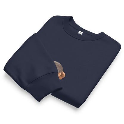 Folded navy blue sweatshirt with a small graphic on a white background