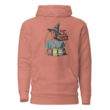 Peach hoodie with a graphic of a person in a witch hat holding potion bottles on a white background