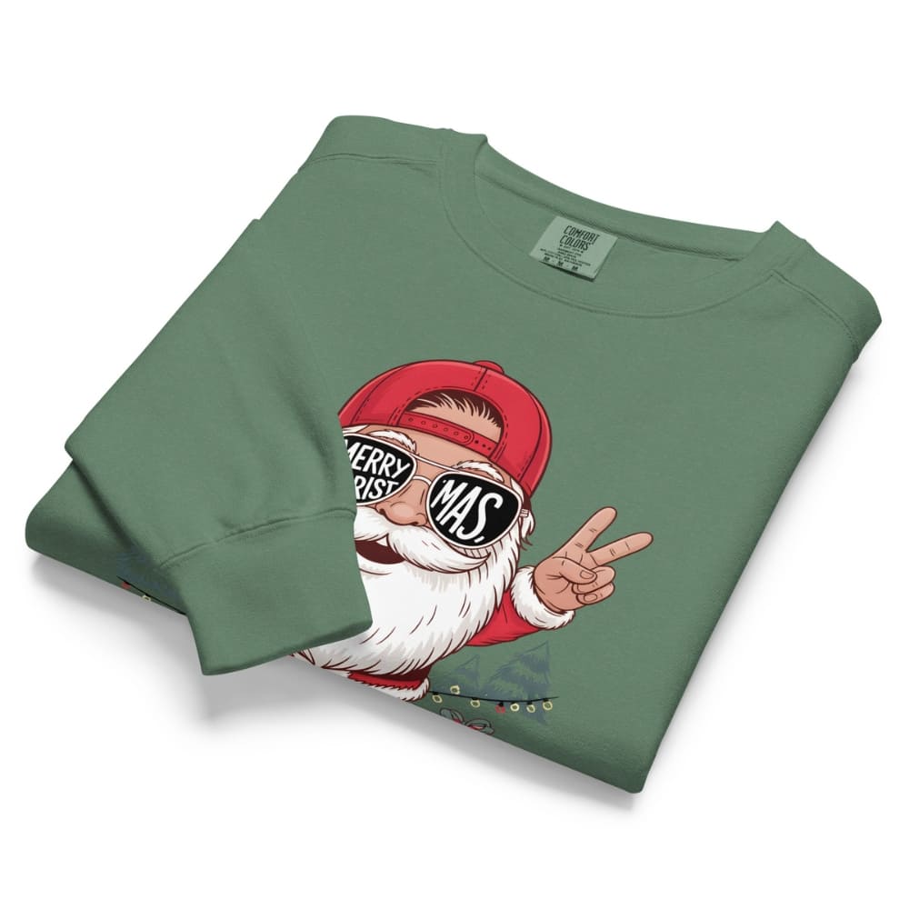 Folded green sweatshirt with a graphic of Santa Claus wearing sunglasses and giving a peace sign on a white background.