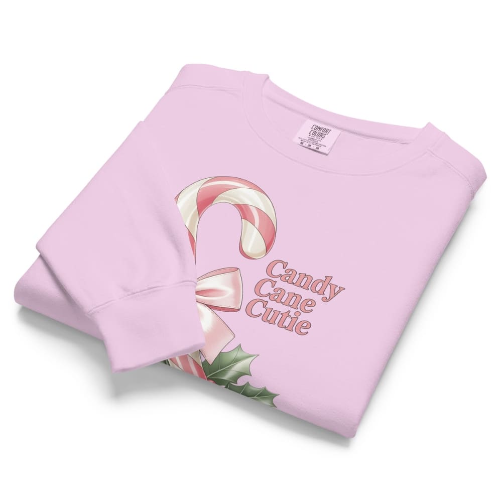 Folded pink hoodie with candy cane design and 'Candy Cane Cutie' text on a white background