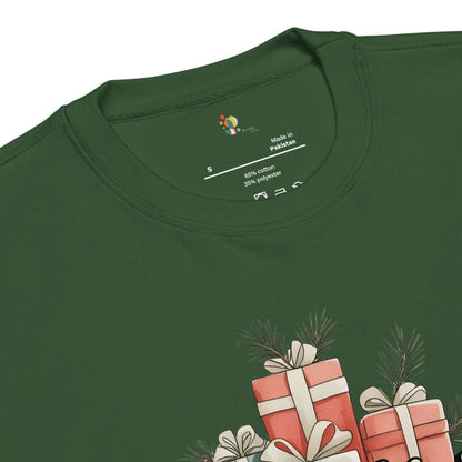 Green t-shirt with Christmas-themed design of presents and tree branches on a white background
