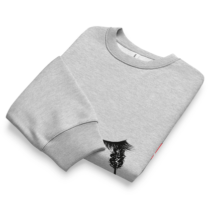 Folded gray sweatshirt with a black graphic design on a white background