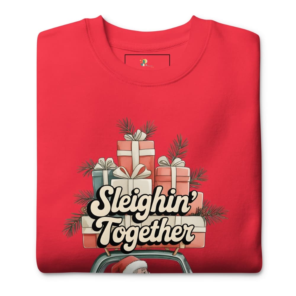 Red t-shirt with Christmas-themed design featuring presents and 'Sleighin' Together' text on a white background.