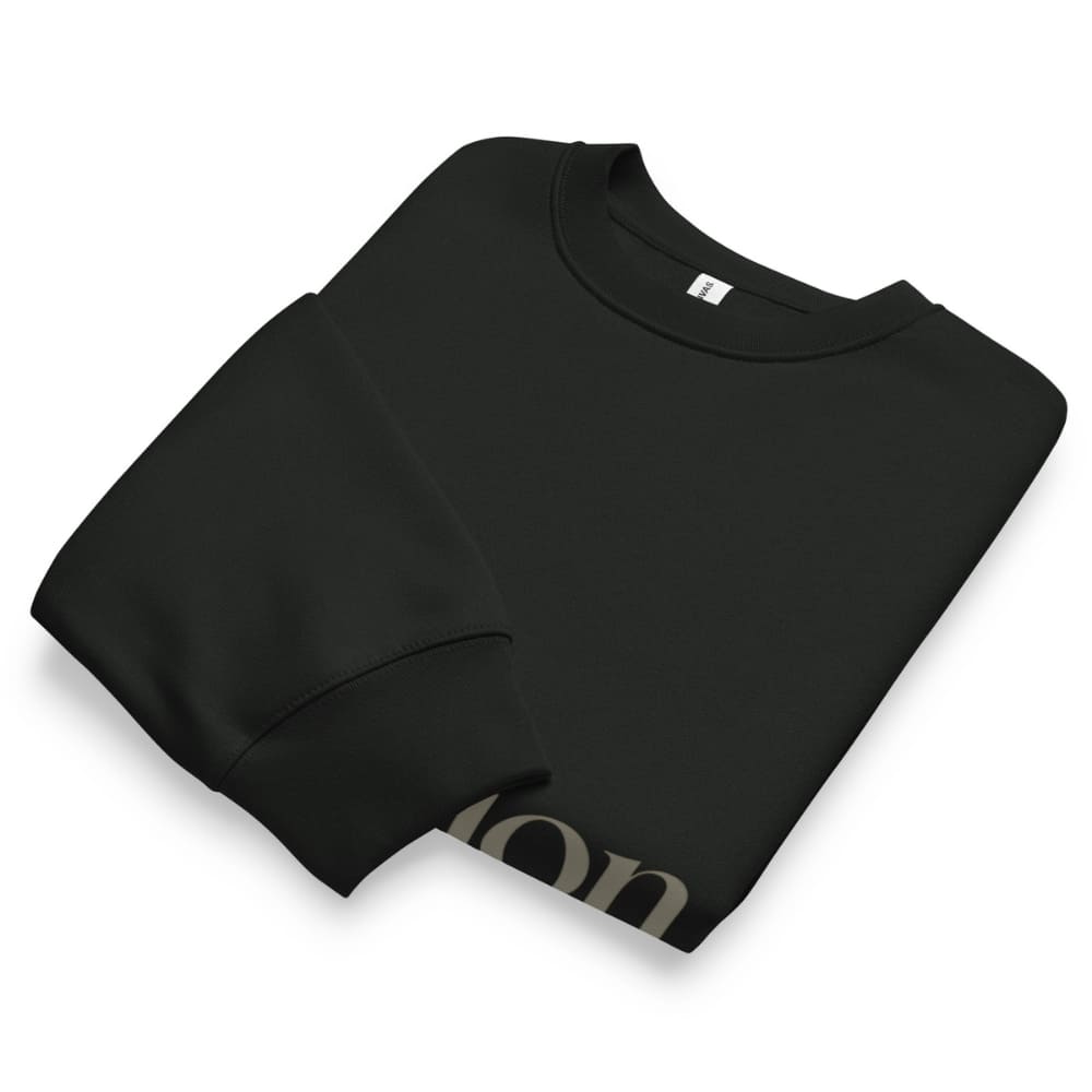 Folded black sweatshirt with 'London' text on a white background