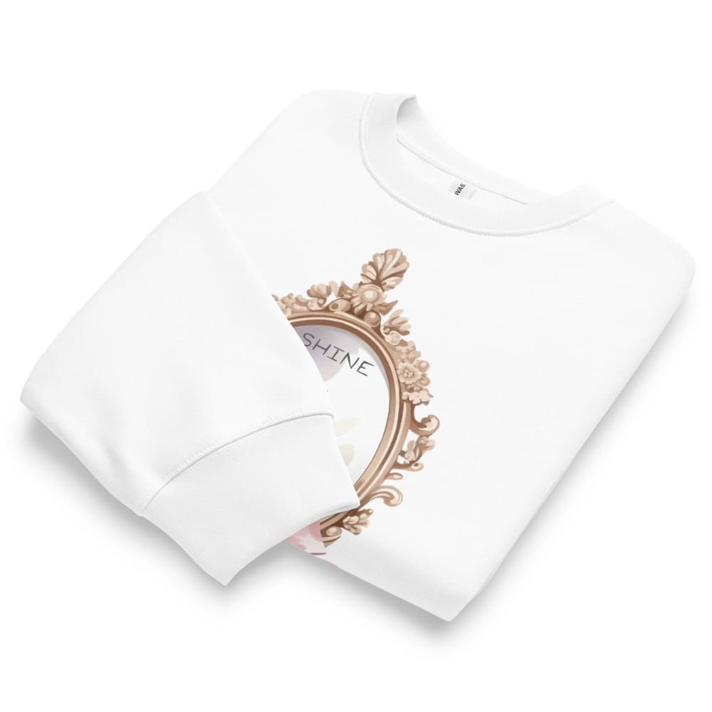 White t-shirt with decorative frame and 'SHINE' text on a white background