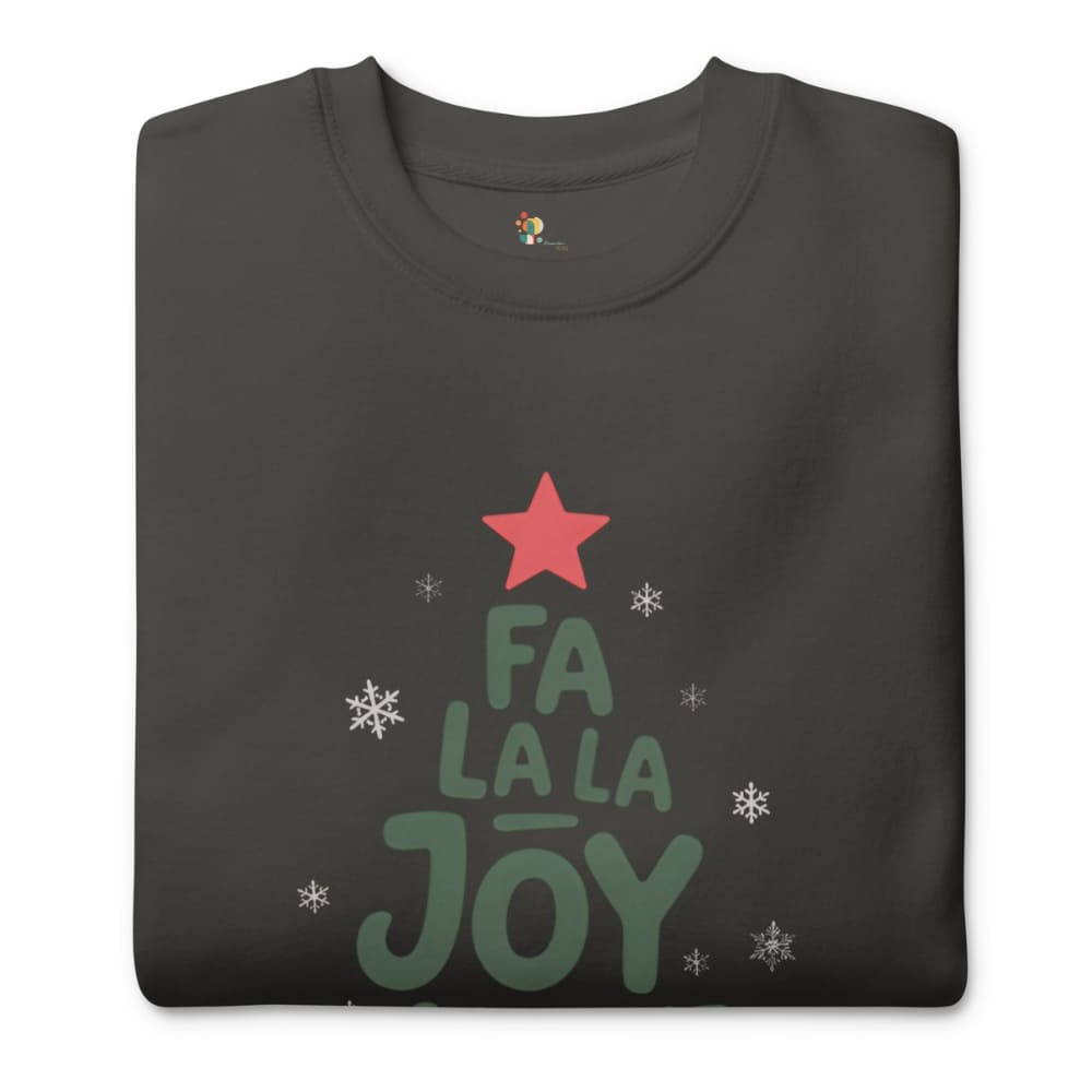 Folded black t-shirt with 'Fa La La Joy' text and star design on a white background