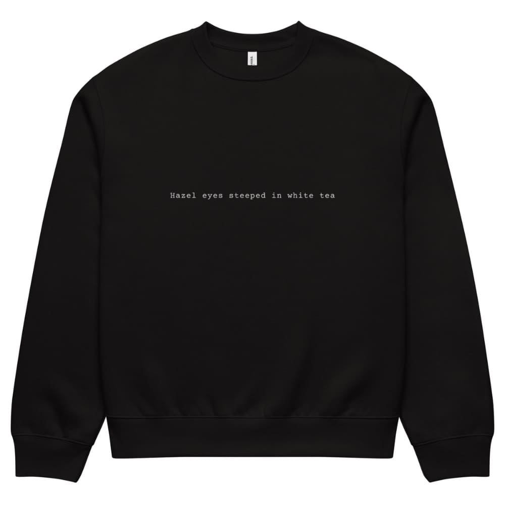 Black sweatshirt with text 'Hazel eyes steeped in white tea' on a white background