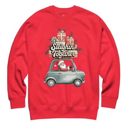 Red sweatshirt with Christmas design featuring Santa driving a sleigh with presents.