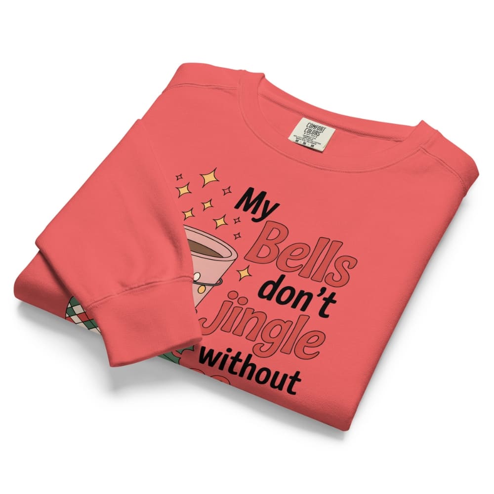 Folded coral sweatshirt with text and graphic design on a white background