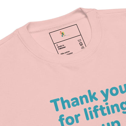 Close-up of a pink t-shirt with text and a label on a white background