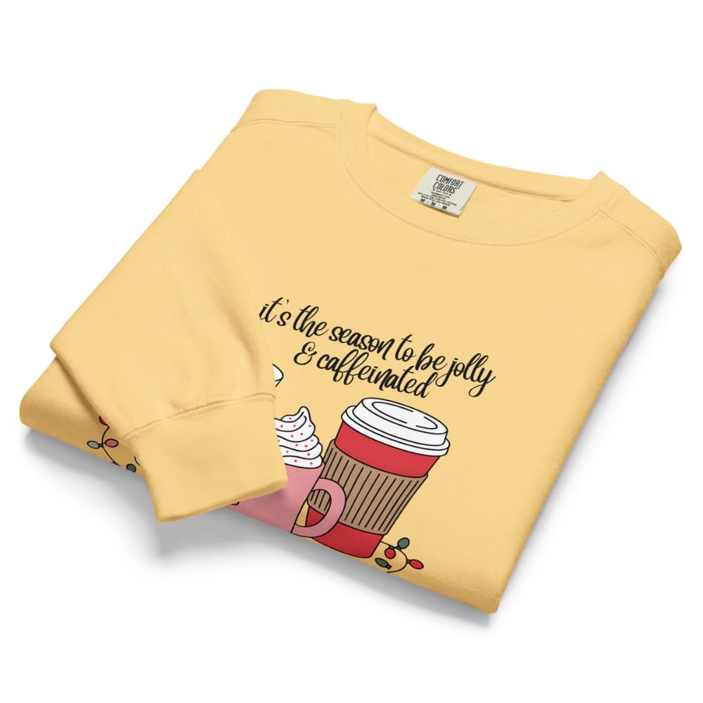 Folded yellow sweatshirt with a graphic and text on a white background