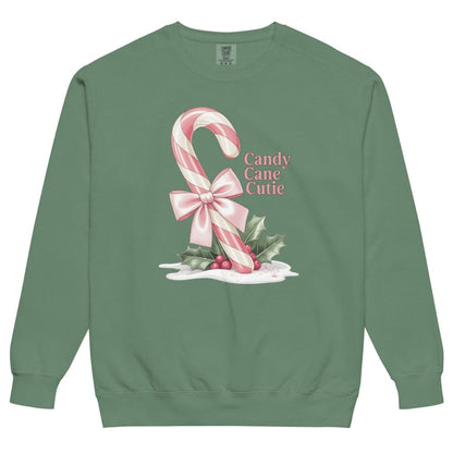 Green sweatshirt with candy cane and bow design on a white background