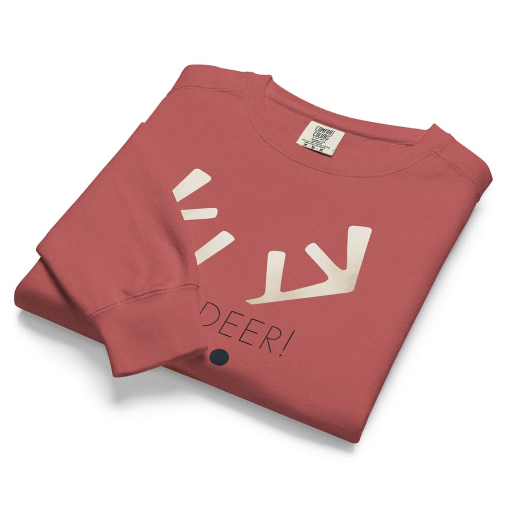 Folded red sweatshirt with white deer design and 'DEER!' text on a white background
