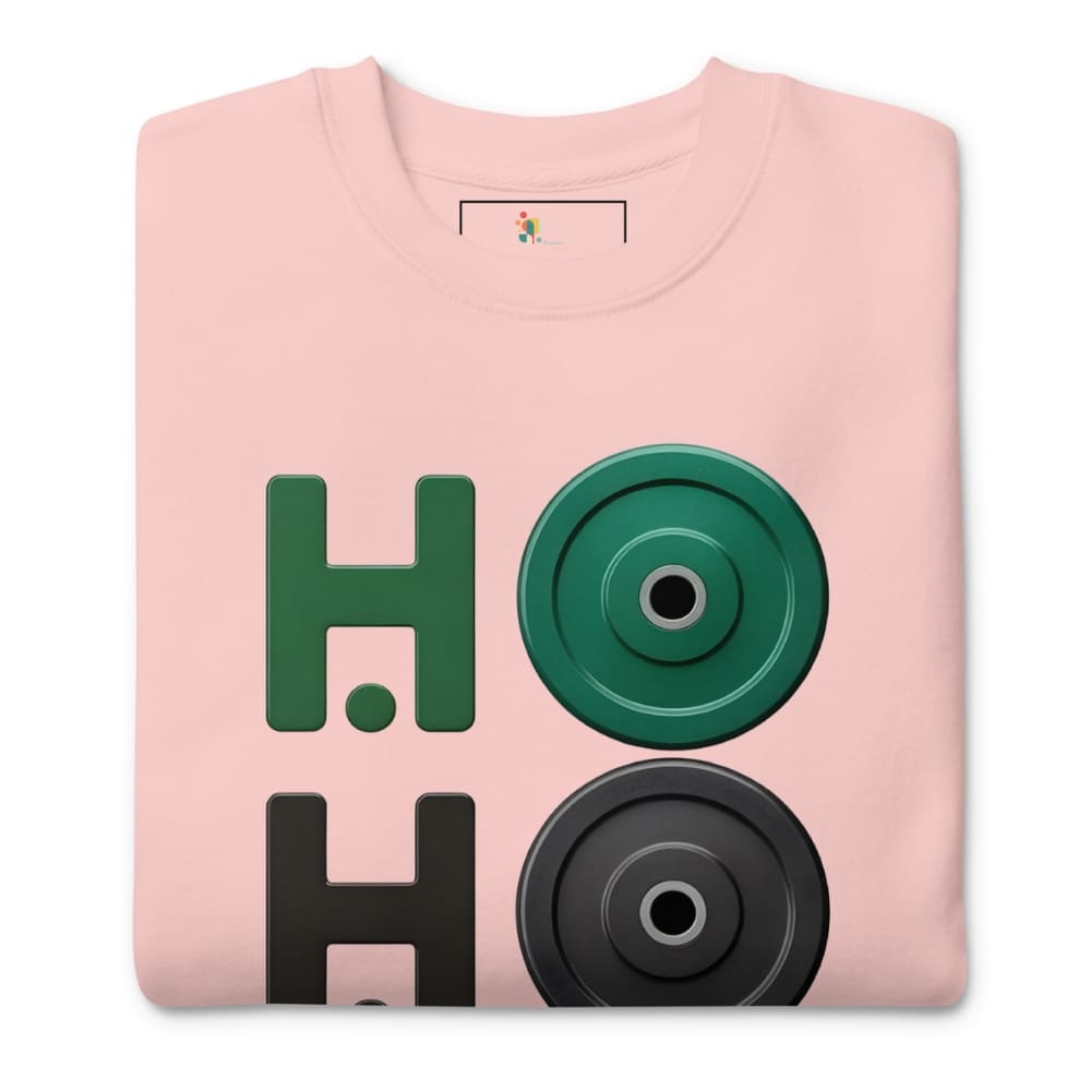 Folded pink sweatshirt with green and black weightlifting disc design on a white background