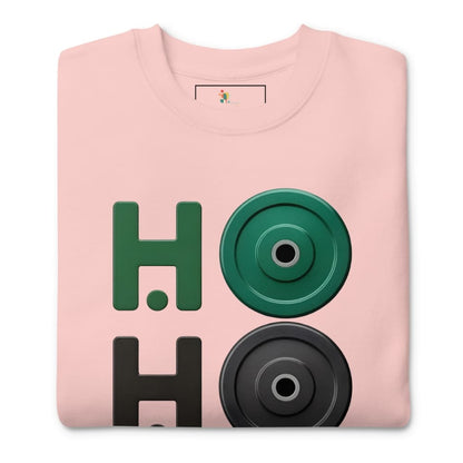 Folded pink sweatshirt with green and black weightlifting disc design on a white background