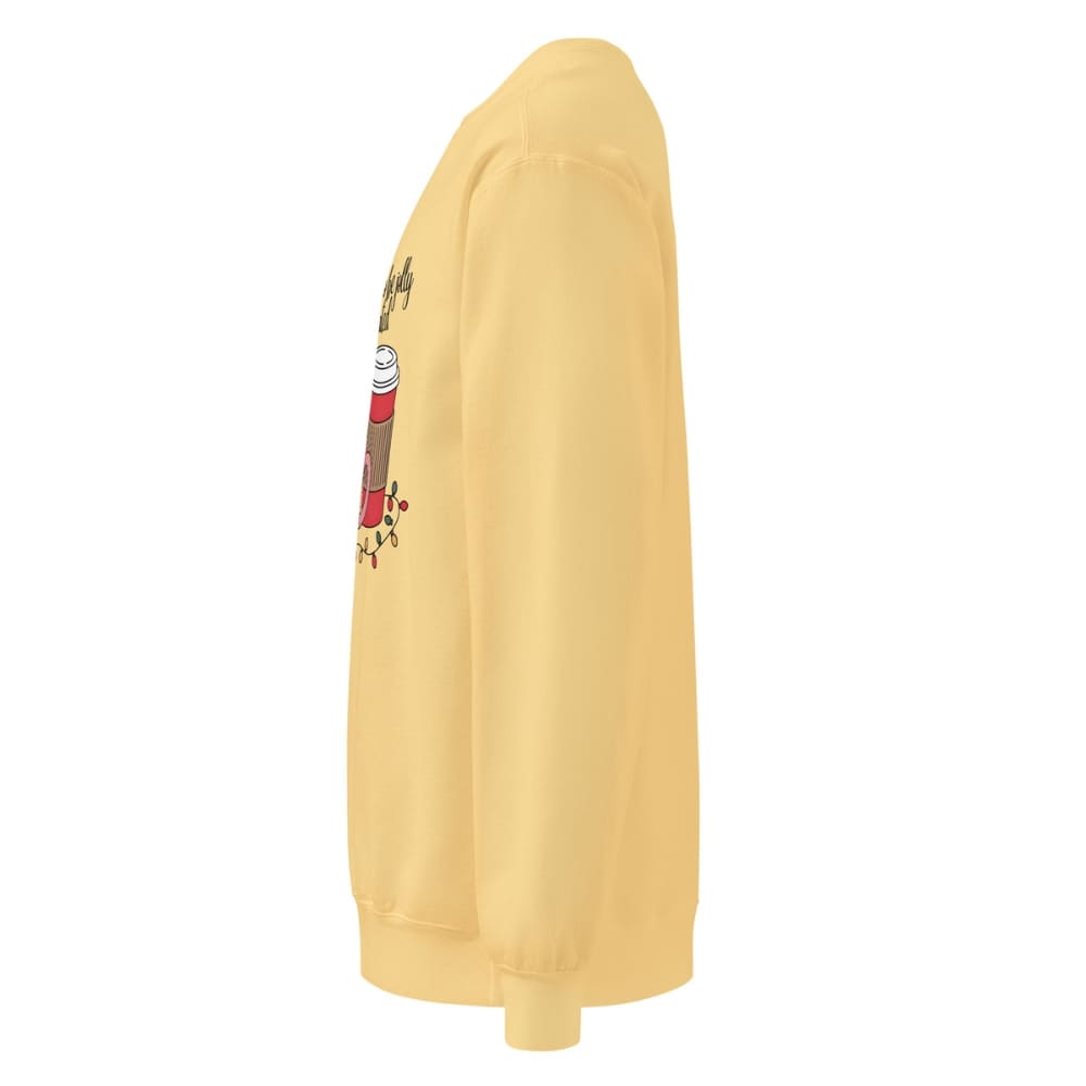 Yellow sweatshirt with a cartoon character on the sleeve against a white background