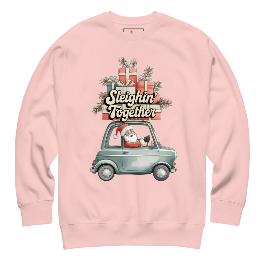 Pink sweatshirt with Christmas design featuring Santa in a car and presents.