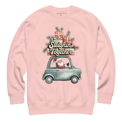 Pink sweatshirt with Christmas design featuring Santa in a car and presents.