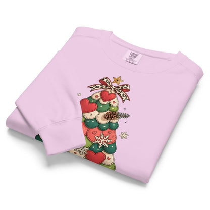 Folded pink sweatshirt with Christmas-themed design on a white background