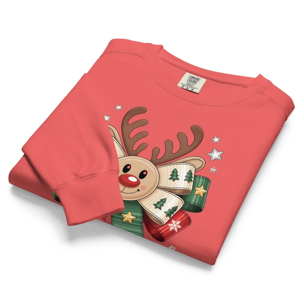 Folded red sweatshirt with a reindeer design on a white background