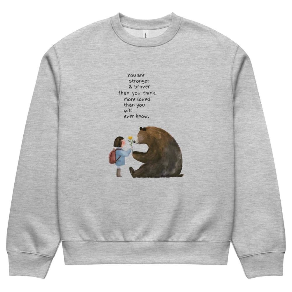 Gray sweatshirt with a graphic of a bear and a girl, and an inspirational quote on a white background.