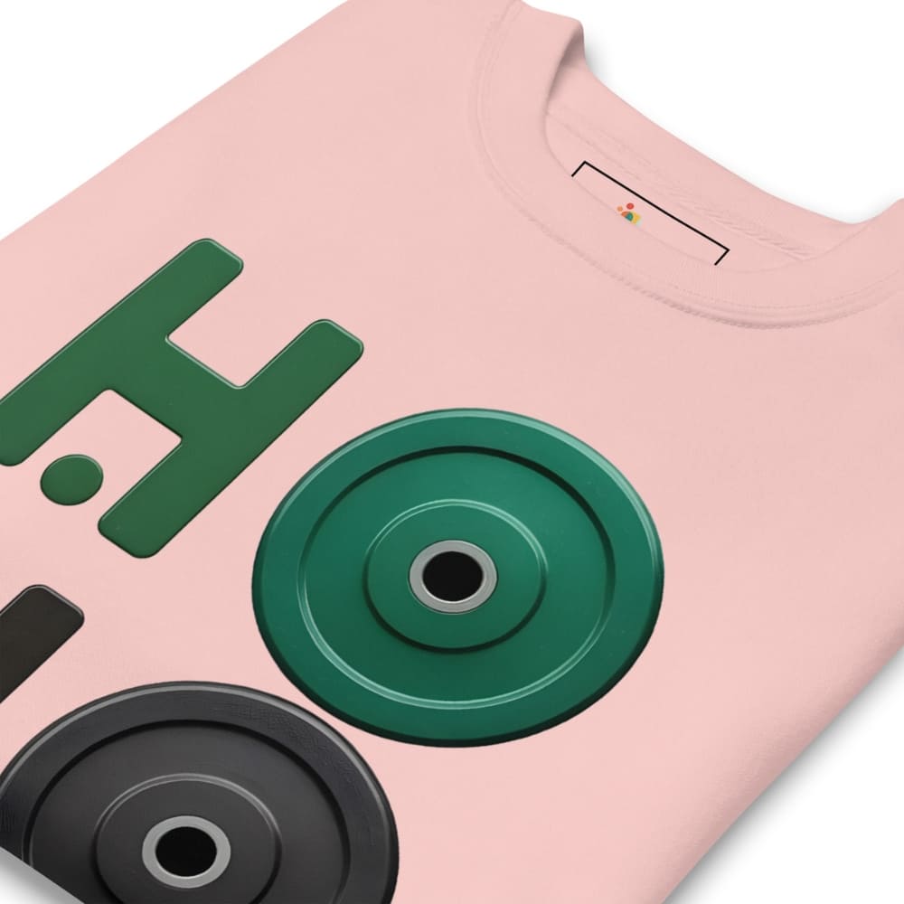 Pink t-shirt with green and black weightlifting disc design on a white background